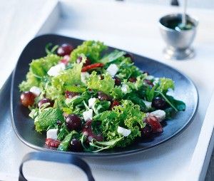 Green salad with grapes, salami and feta