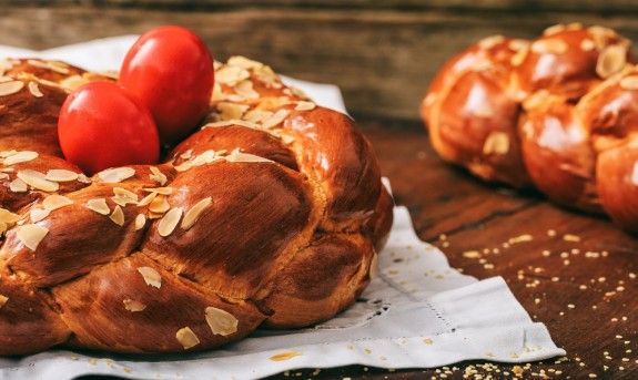 75662731 – easter traditional bread and red eggs on a table