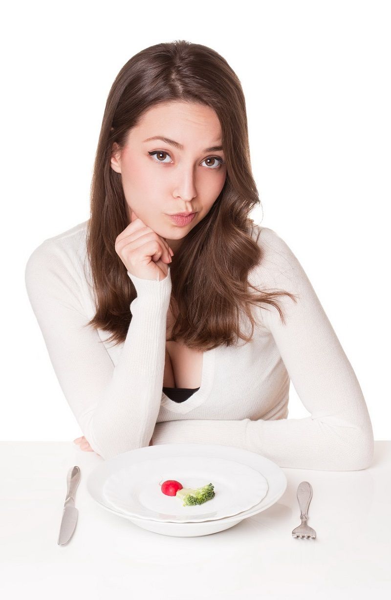 38211830 – portrait of a beautiful young brunette woman in diet dilemma.