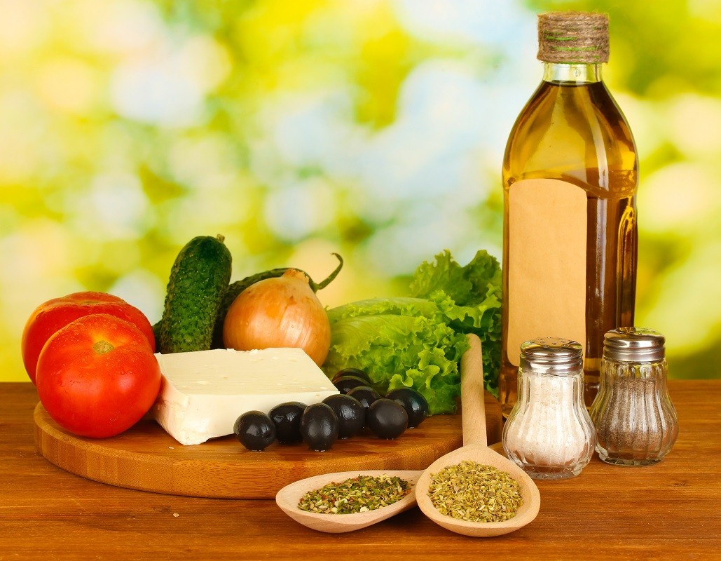 14358038 – ingredients for a greek salad on green background close-up