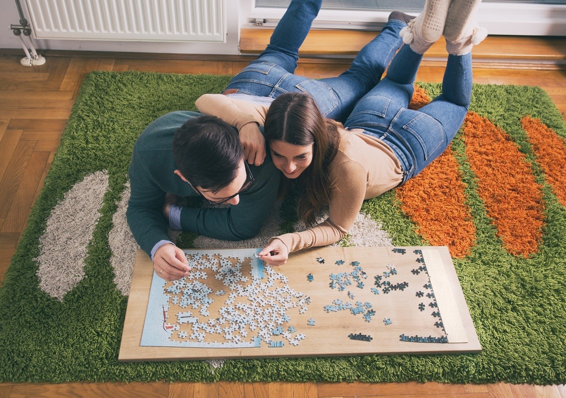 Couple having fun with puzzle