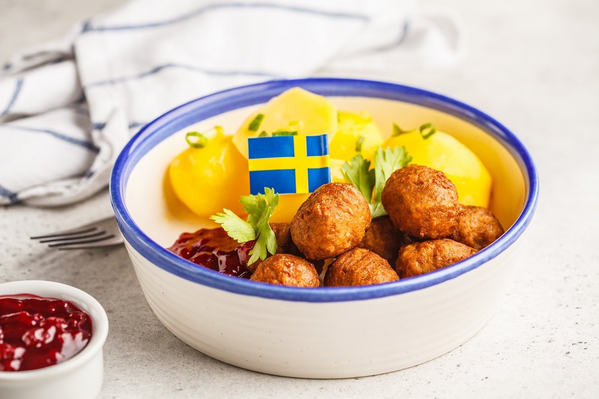 Swedish meatballs with boiled potatoes and cranberry sauce. Swed