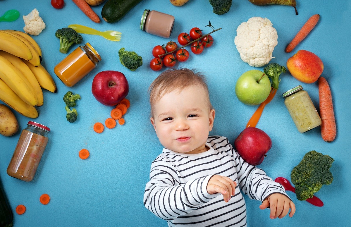 Baby surrounded with fruits and vegetables