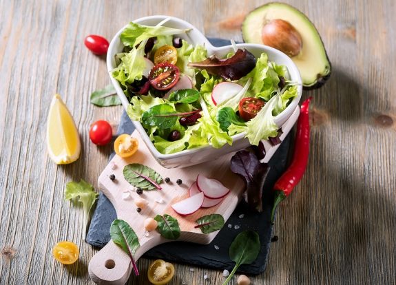 Healthy green salad with avocado, mangold leaves, red beans and