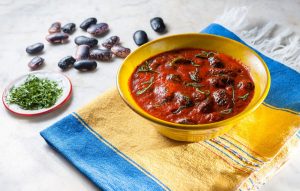 Μαύροι γίγαντες στη γάστρα με σάλτσα κόκκινης πιπεριάς και κόλιανδρο