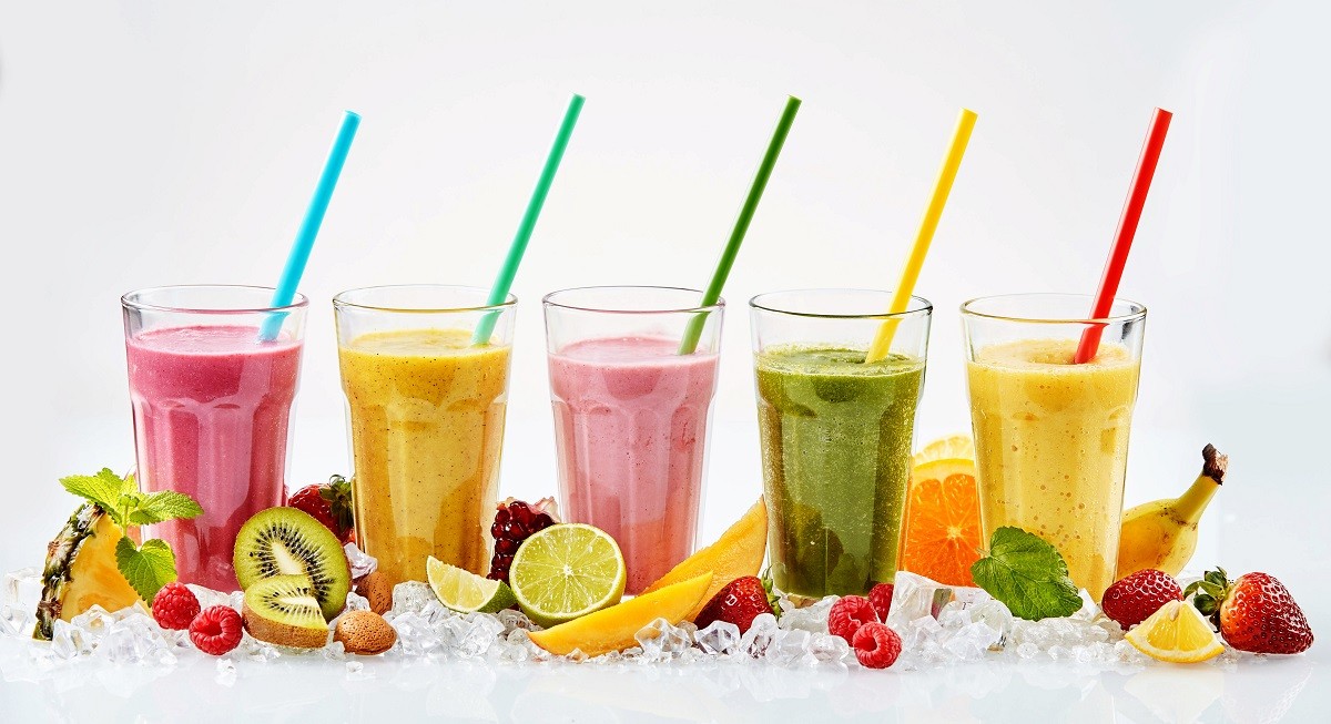 Five tall glasses of tropical fruit smoothies