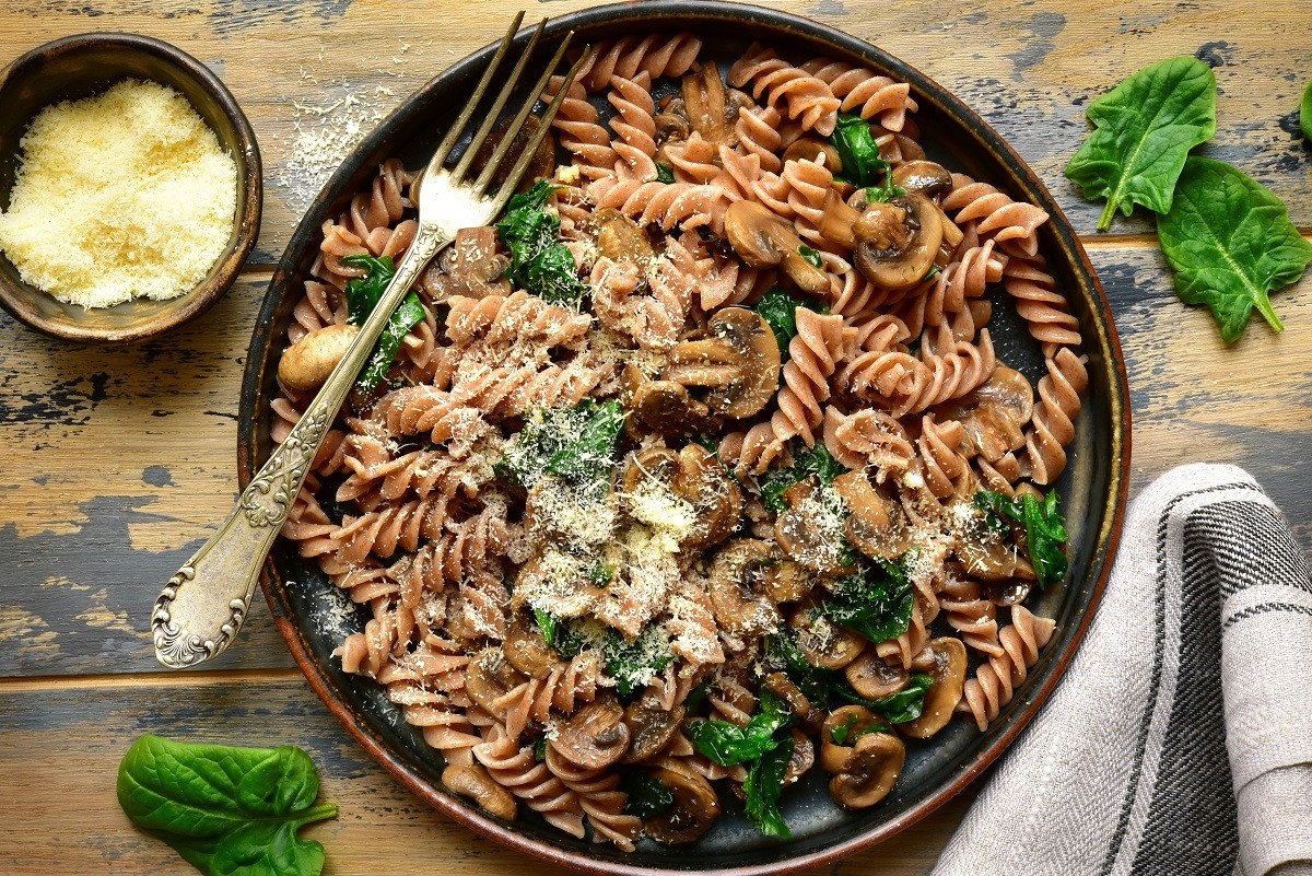 Whole wheat fusilli pasta with mushroom and spinach.Top view wit