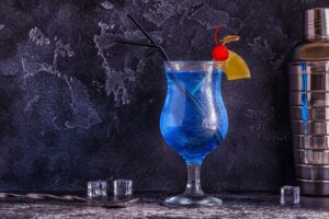Blue Curacao cocktail decorated with fruit.