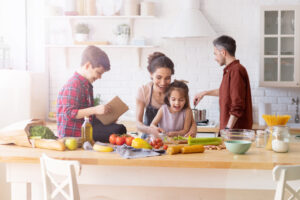 Happy,Family,Cooking,Together,On,Kitchen.,Mother,And,Daughter,Reading