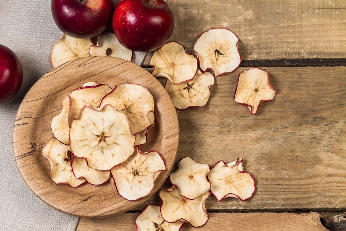 Homemade,Dehydrated,Apple,Chips,And,Ripe,Red,Apples,On,A