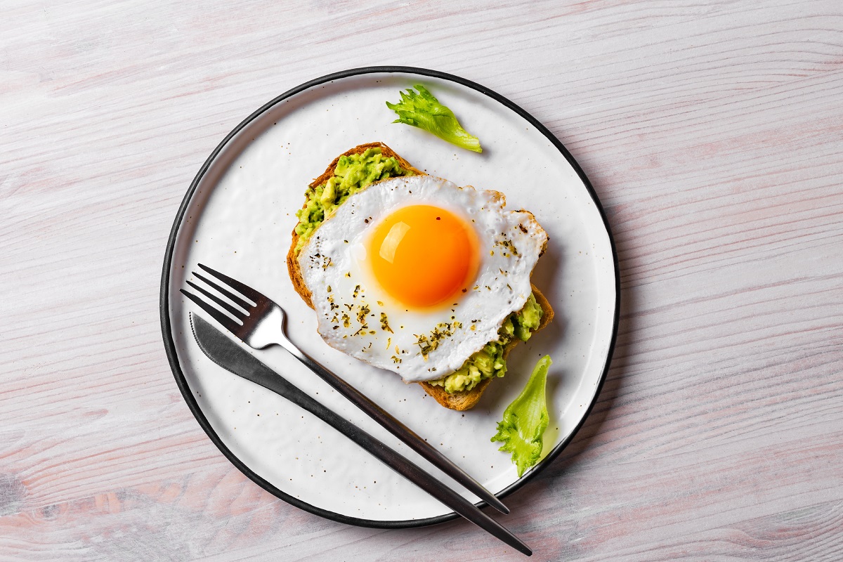 Avocado,Toast,With,Fried,Egg,On,Wooden,Table.,Toasted,Bread