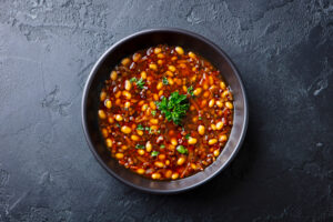 Bean,Soup,In,A,Black,Bowl.,Dark,Background.,Close,Up.