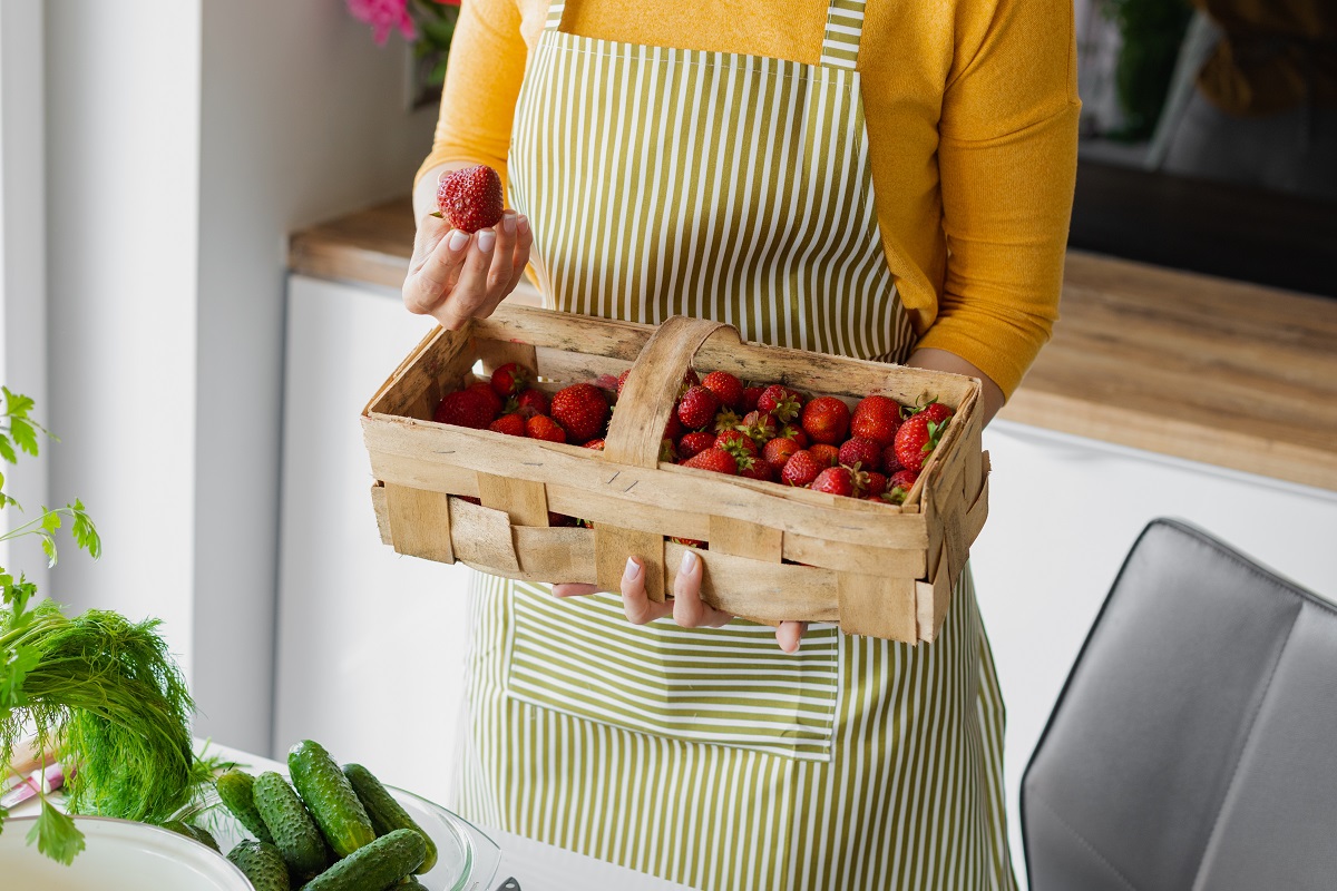 Cropped,Closeup,Woman,Hands,Holding,Box,Of,Strawberry,Next,To