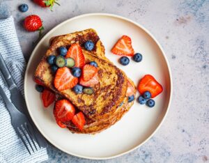 Traditional,French,Toasts,With,Blueberries,And,Strawberries,On,A,White