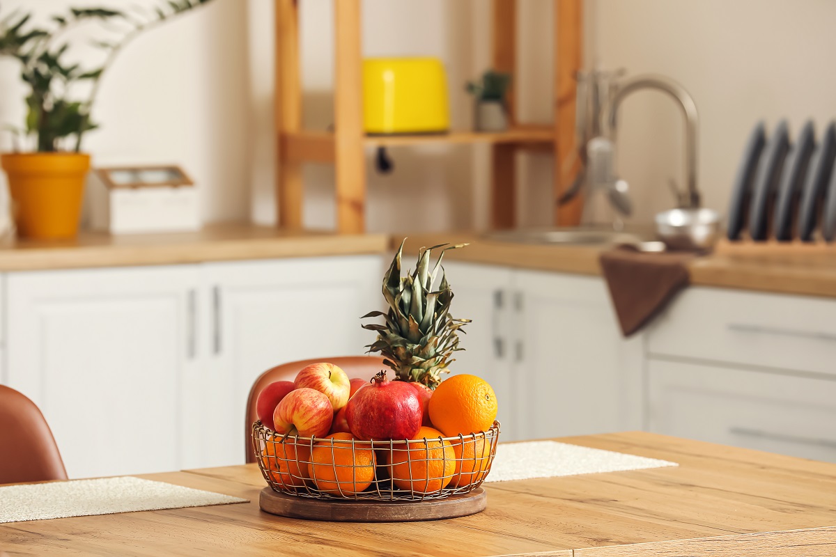 Basket,With,Fresh,Fruits,On,Wooden,Table,In,Kitchen