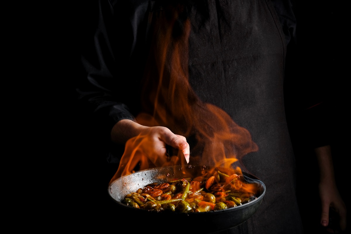 Professional,Chef,And,Fire.,Cooking,Vegetables,And,Food,Over,An