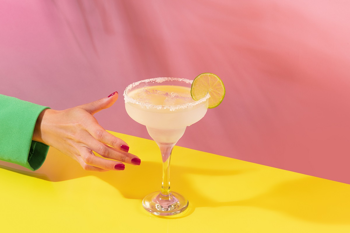 Female,Hand,Taking,Glass,Of,Delicious,Margarita,Cocktail,Isolated,Over