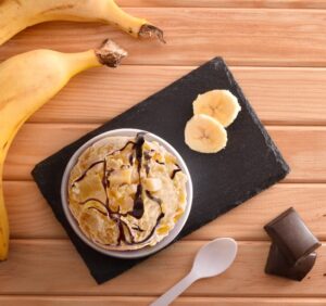 Banana,Ice,Cream,Cup,Decorated,With,Chunks,And,Syrup,Chocolate