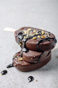 Ice,Cream,Bar,Coated,With,Chocolate,And,Nuts.