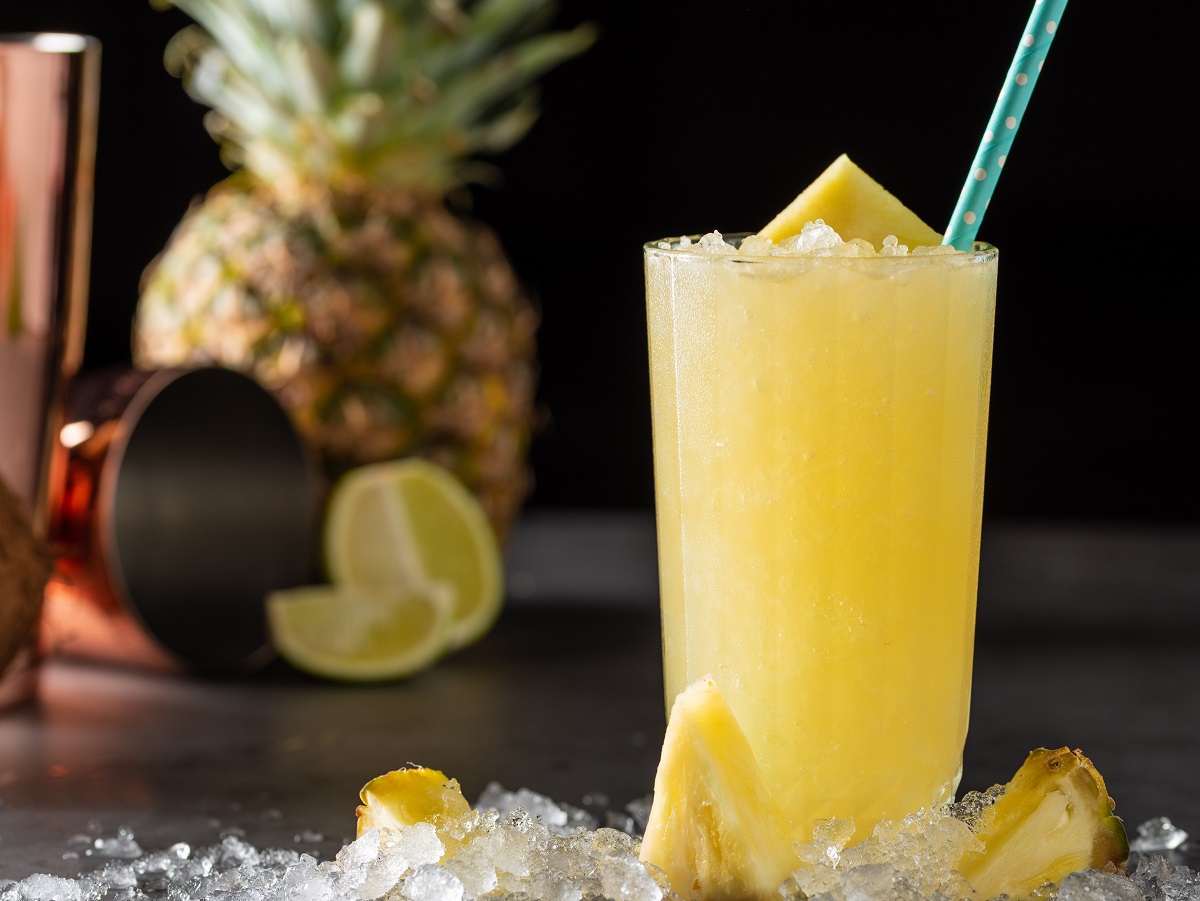 Cocktail,With,Pineapple,,Coconut,And,Lemon,On,Stone,Background
