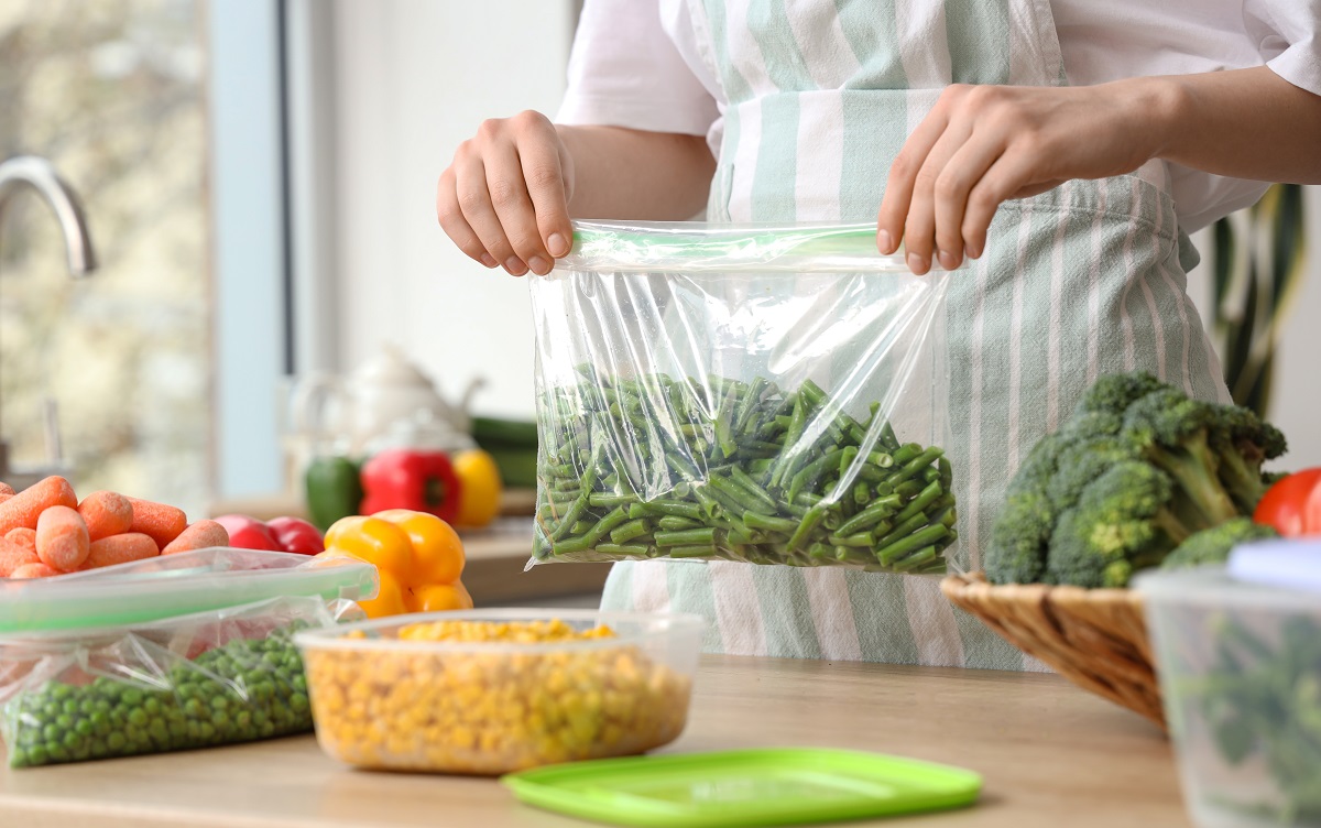 Woman,Holding,Plastic,Bag,With,Green,Beans,For,Freezing,In