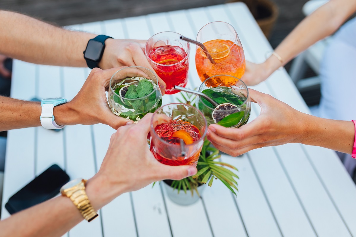 Group,Of,Friends,Toasting,Multicolored,Cocktails,At,The,Summer,Terrace