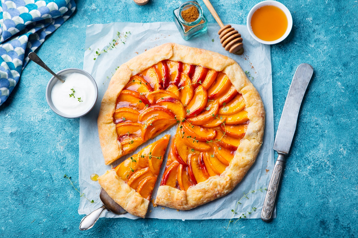 Peach,Galette,,Pie,,Cake,With,Cream,On,Blue,Background.,Top