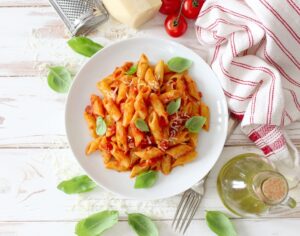 Penne,Pasta,With,Tomato,Sauce,,Parmesan,Cheese,And,Basil,On