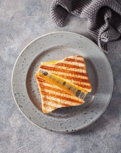 Grilled,Cheese,Sandwich,On,Gray,Concrete,Background