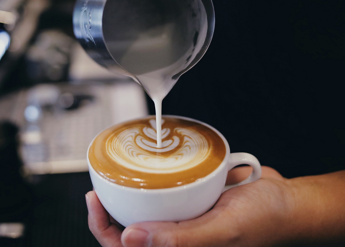 Barista,Pouring,Milk,Into,A,Coffee,Mug,close,Up,Barista,Hand