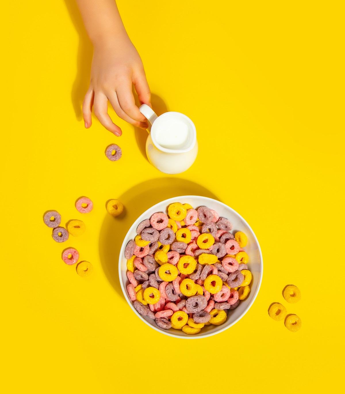 Bowl,Of,Colorful,Cereal,Corn,Rings,On,Yellow,Table.,Breakfast