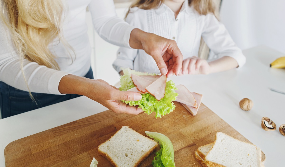 Mother,Preparing,Sandwich,For,School,Lunch,On,Table,Close,Up