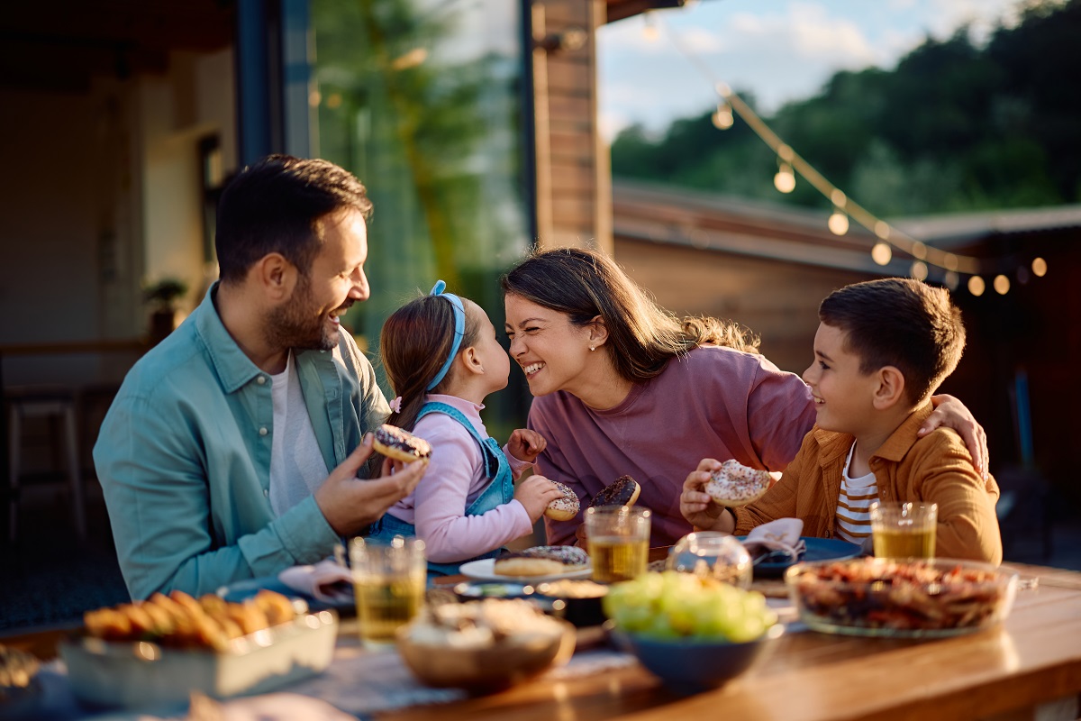 Happy,Family,Having,Fun,While,Eating,At,Dining,Table,On