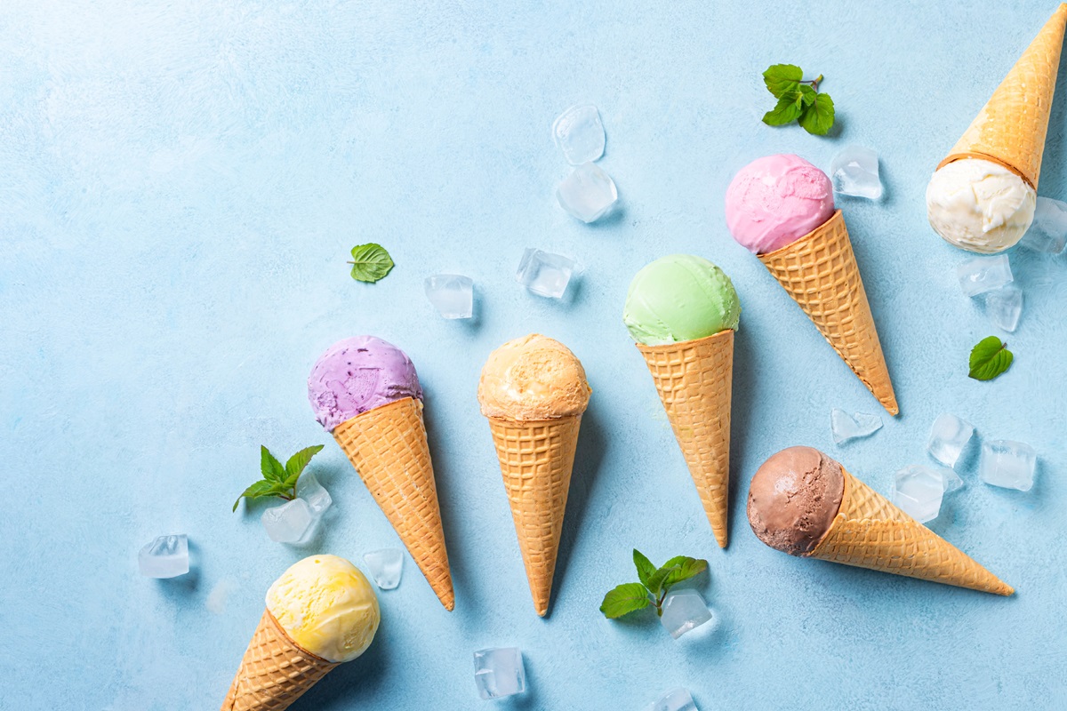 Various,Ice,Cream,Scoops,In,Cones,On,Blue,Background,,Top