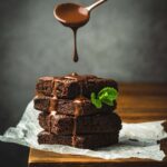 A,Stack,Of,Chocolate,Brownies,On,Wooden,Background,With,Mint