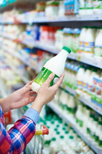 Woman,Shopping,Milk,In,Grocery,Store