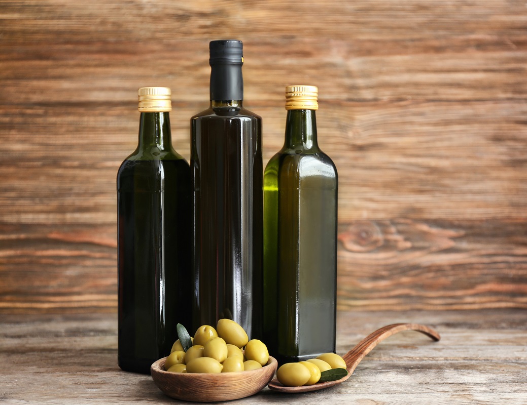 Composition,With,Olives,And,Oil,In,Bottles,On,Wooden,Background