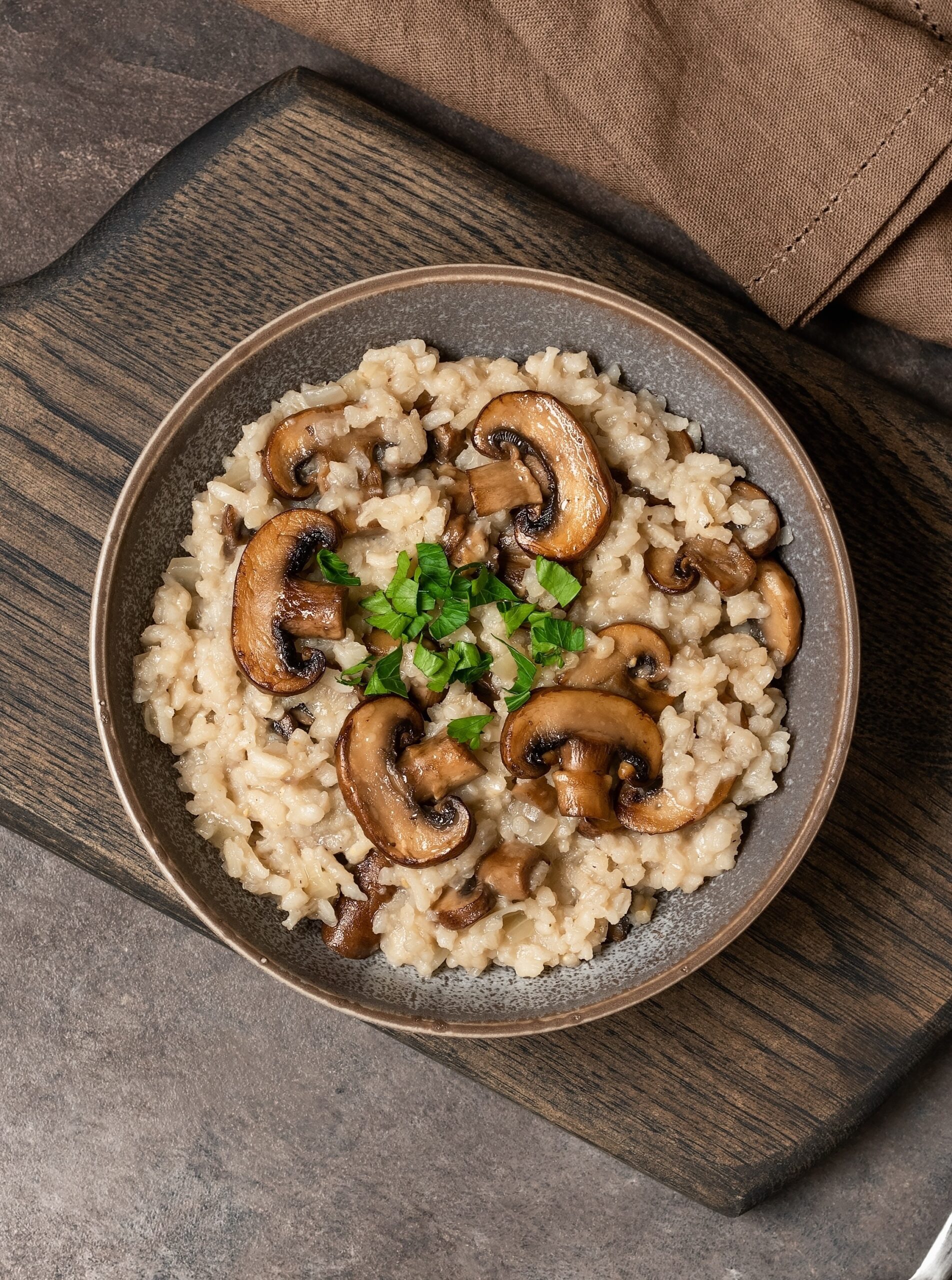 Risotto,With,Mushrooms,In,A,Plate,On,A,Wooden,Cutting