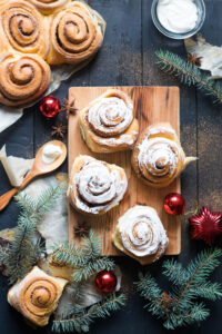 Freshly,Baked,Cinnamon,Buns,Cinnabons,With,Cream,On,Parchment,Paper