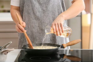 Woman,Cooking,Risotto,In,Kitchen