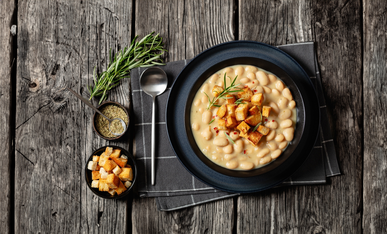 Rosemary,Garlic,White,Bean,Soup,Topped,With,Homemade,Croutons,In