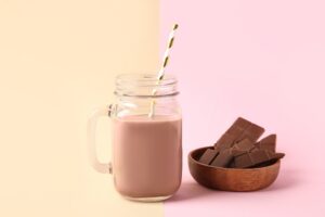 Mason,Jar,Of,Sweet,Chocolate,Milk,On,Colorful,Background