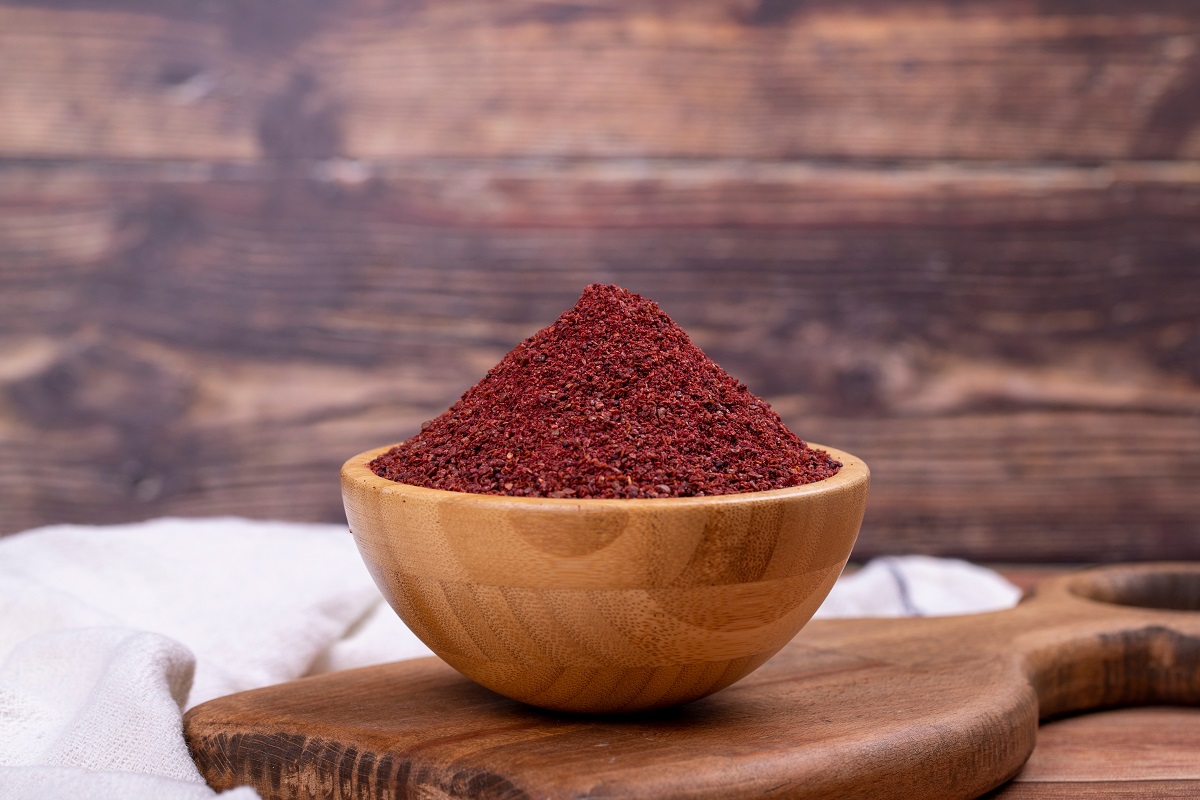 Sumac,On,Wooden,Background.,Dried,Ground,Red,Sumac,Powder,Spices