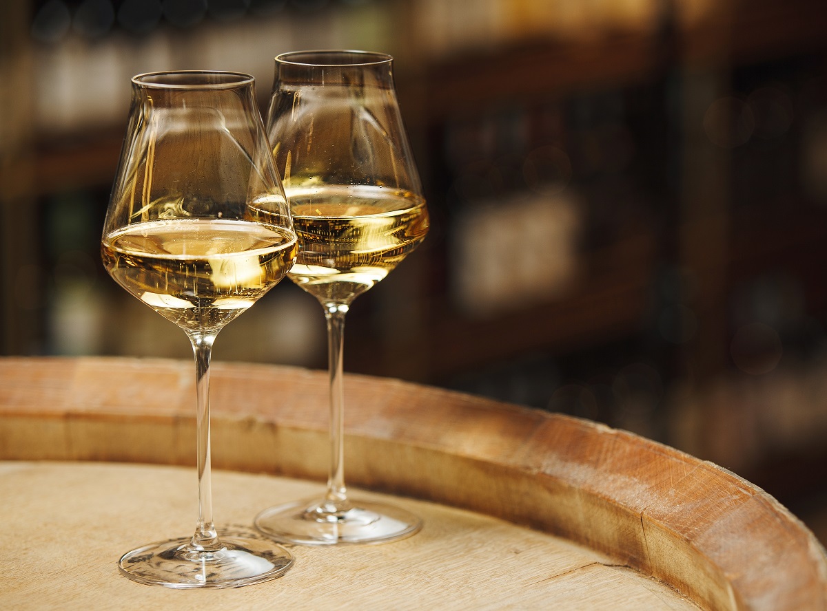 Two,Glasses,Of,White,Wine,On,Wooden,Barrel,,Close,Up