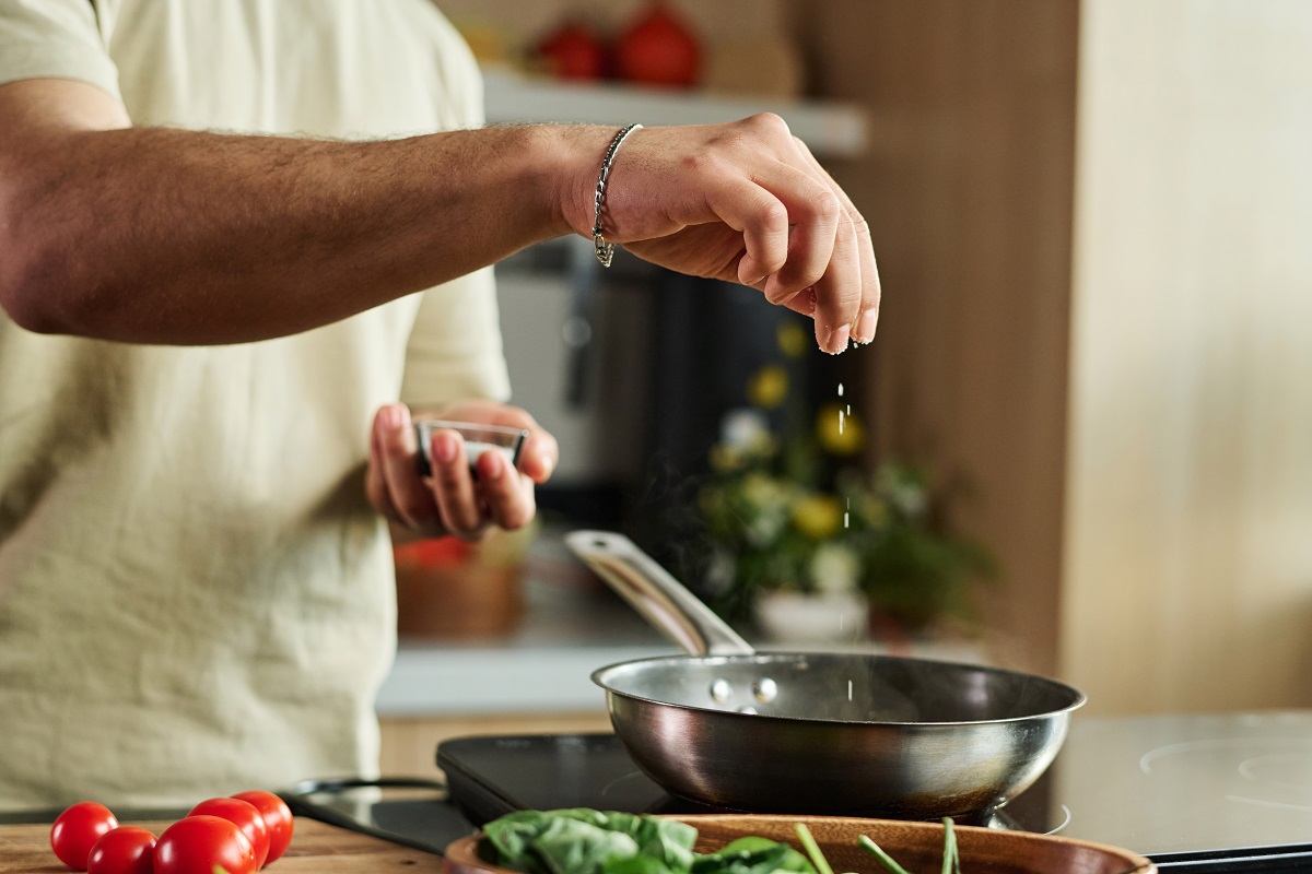 Closeup,Of,Hands,Of,Unrecognizable,Man,Adding,Salt,To,Meal