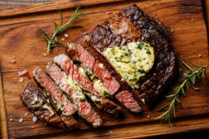 Sliced,Grilled,Medium,Rare,Barbecue,Steak,Ribeye,With,Herb,Butter