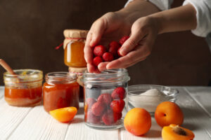 Woman,Puts,Strawberries,In,A,Jar.,Preparing,Jam