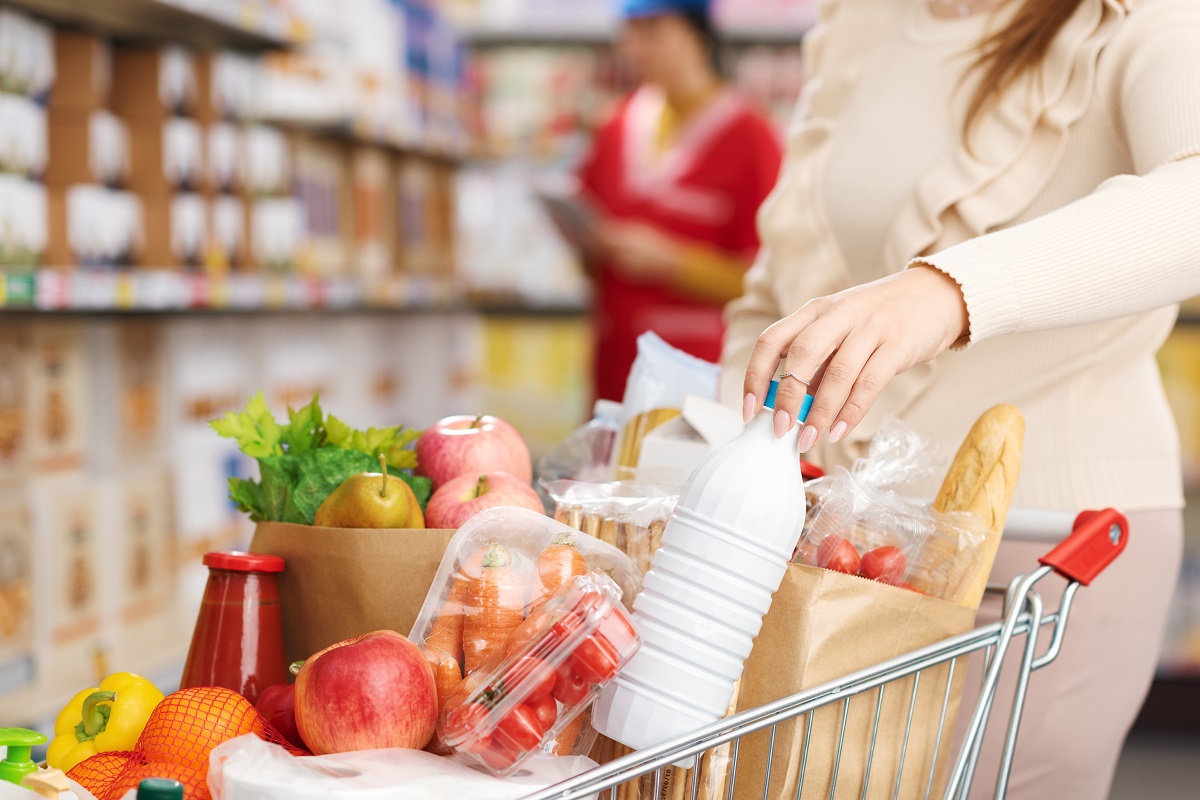 Woman,Buying,Fresh,Groceries,At,The,Supermarket,,She,Is,Pushing