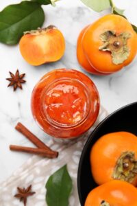 Jar,Of,Tasty,Persimmon,Jam,And,Ingredients,On,White,Marble