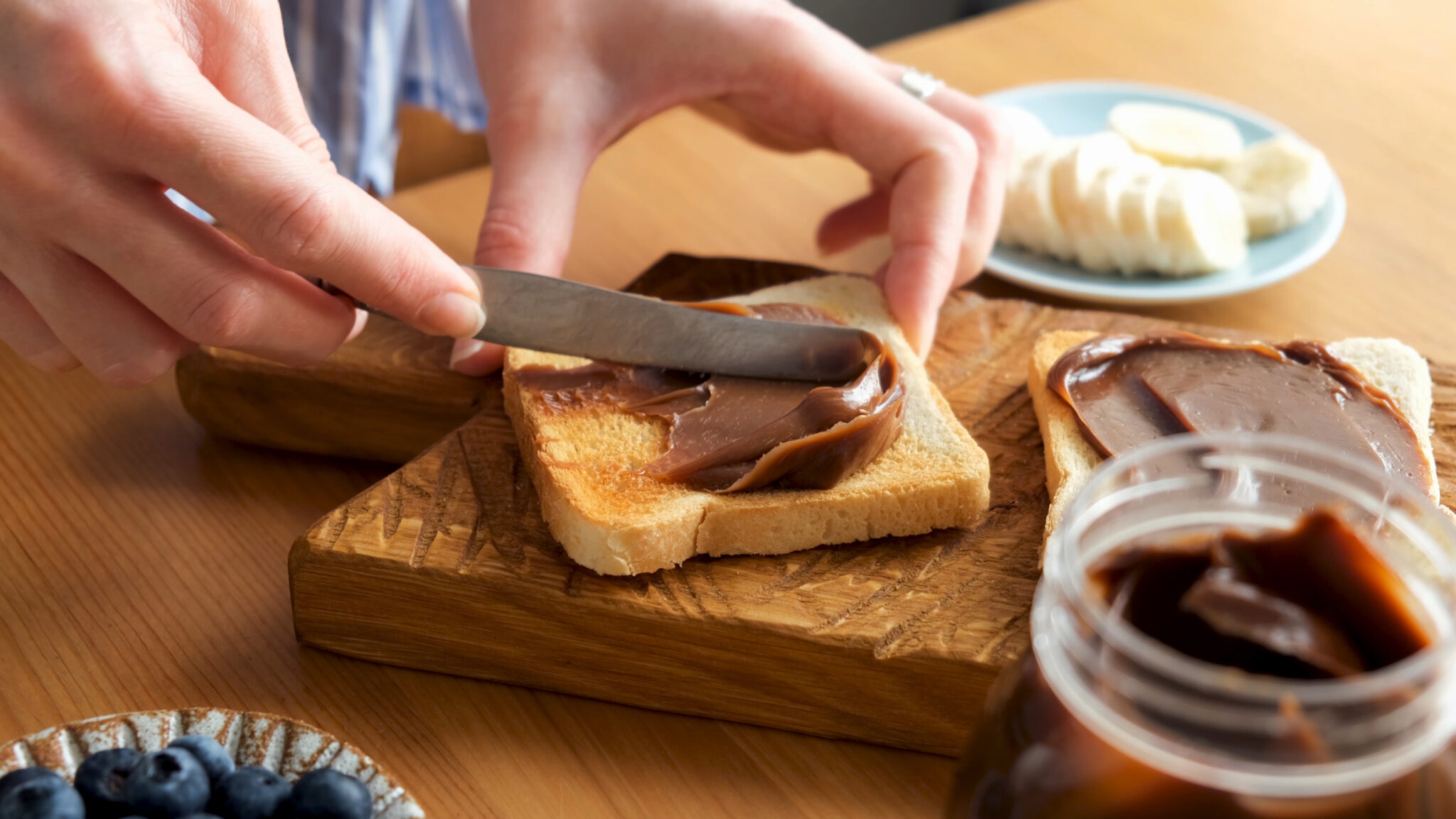 Spreading,Chocolate,Nut,Butter,On,Toasted,Bread.,Female,Hands,Smear